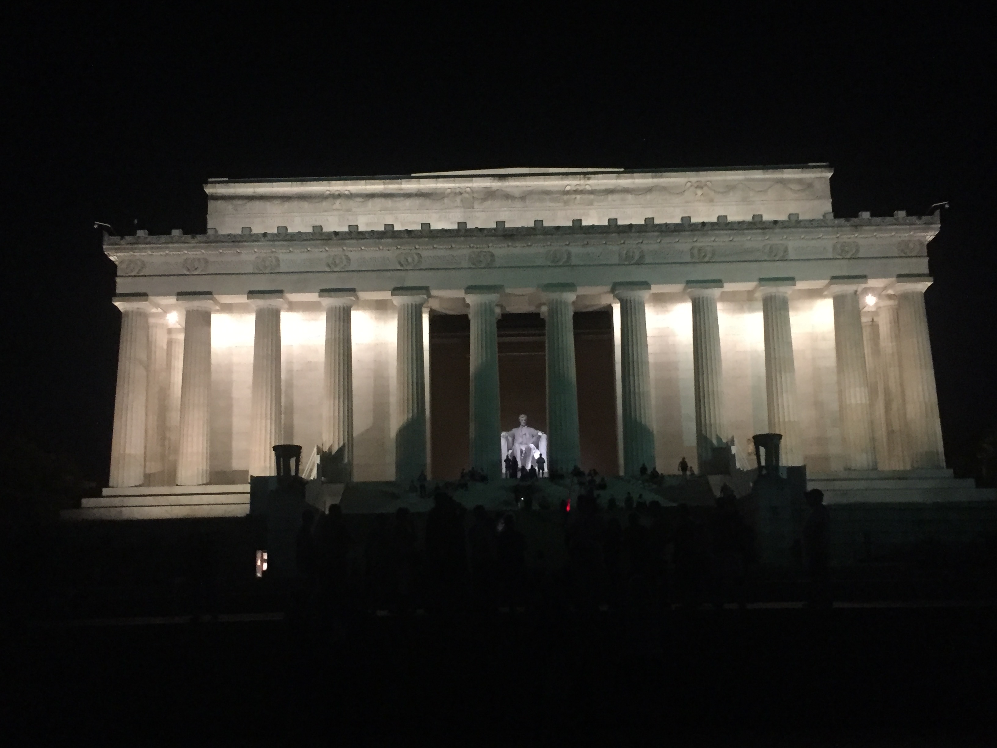 Image of the Lincoln Memorial at night, lit with white lights