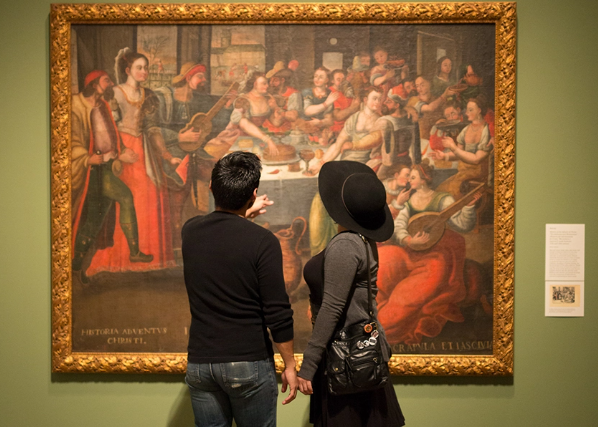 Two individuals admiring painting